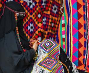 Woman practicing traditional Kuwaiti Al-Sadu weaving with colorful geometric patterns 