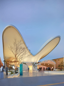 The Kuwait Pavilion at Expo 2025 Osaka with futuristic wing-shaped architecture illuminated at twilight 
