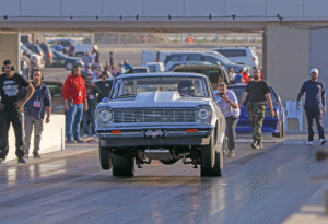 Drag racing action at Kuwait Motor Town showcasing powerful vehicle launches and event excitement