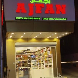 An assortment of labeled gourmet chocolates displayed on shelves in a store, highlighting premium varieties like Buttermint Cream and Rose Cream